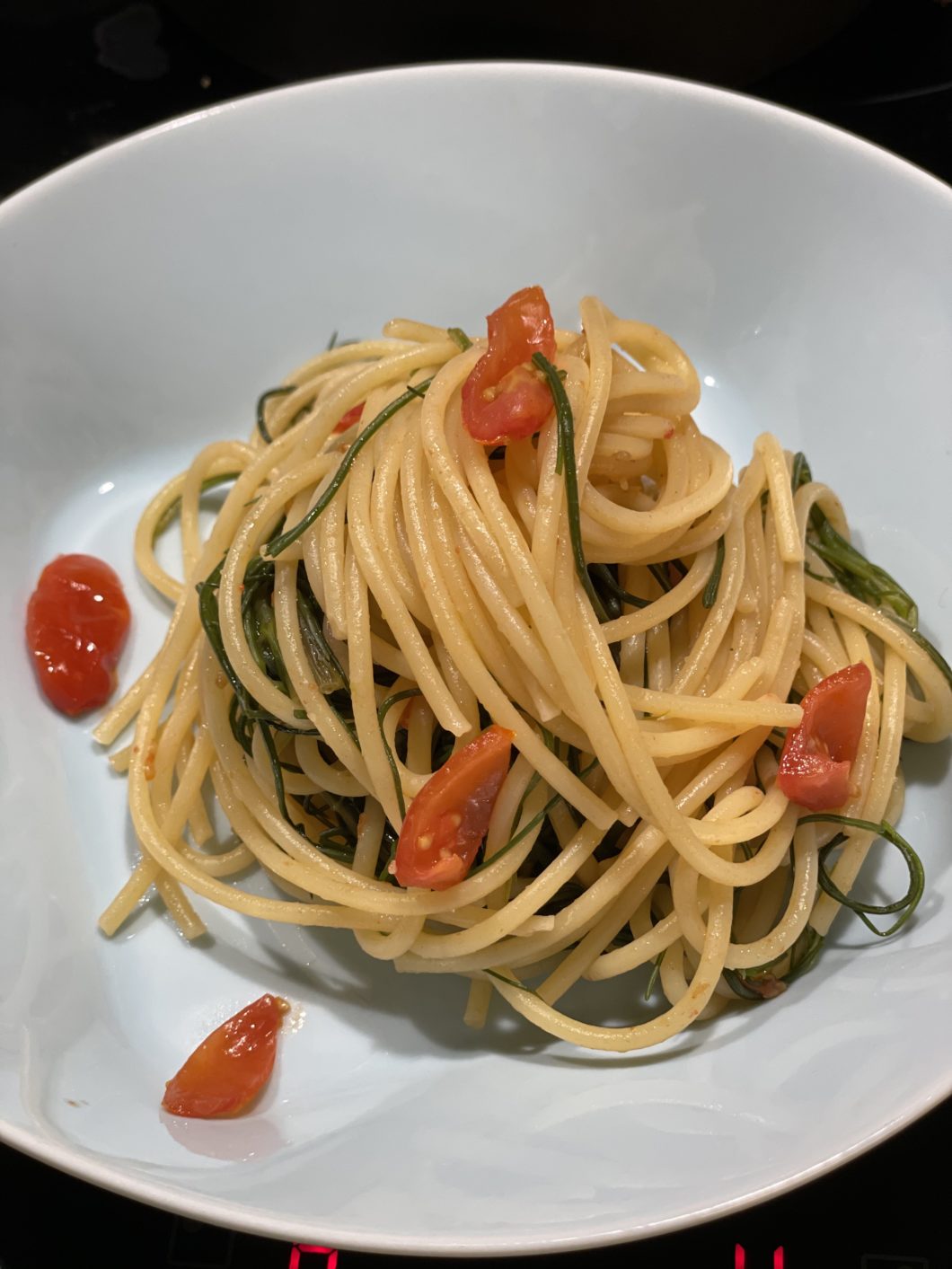 piatto di spaghetti agretti e pomodorini